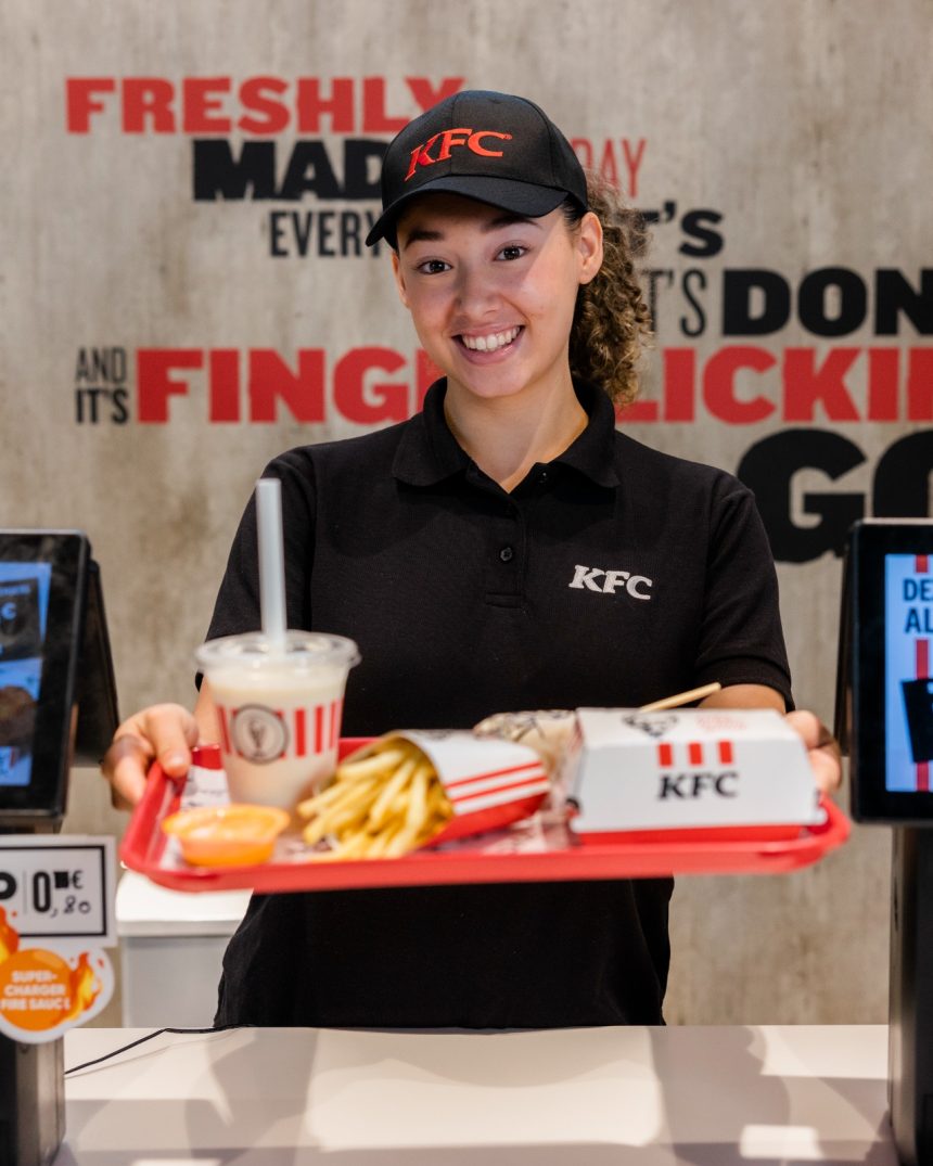 KFC team member at the counter with an order on a tray